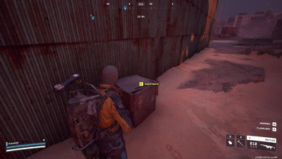 The cache is outside of the warehouse on the east side of the building